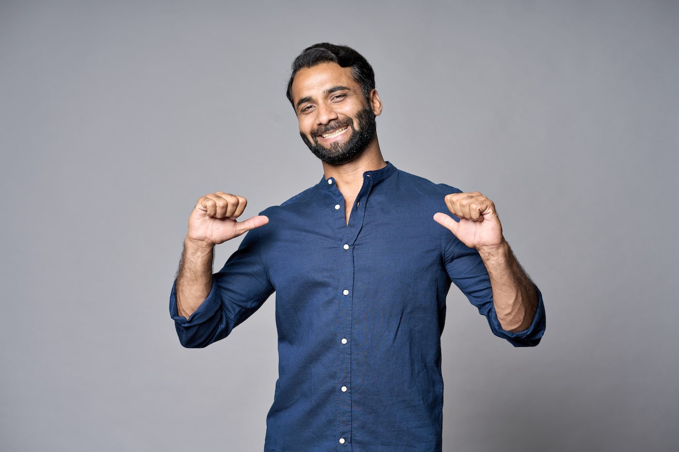 bragging man in denim shirt points at himself